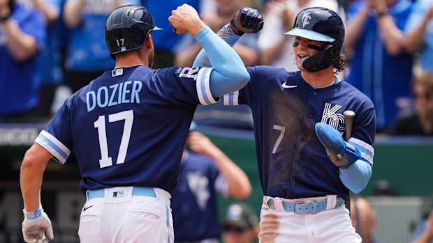 Hunter Dozier fist bumps Bobby Witt Jr.